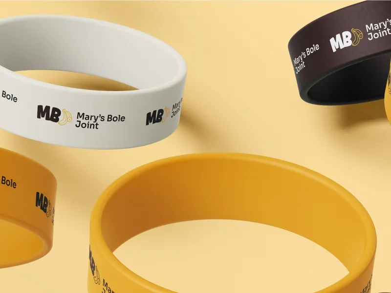 Mary’s Bole Joint wristbands in cream, golden yellow and chocolate, printed with the MB plantain mark